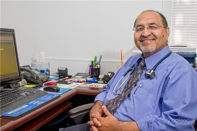 Dr. Jamal U. Zia at his desk at Medico Family Clinic