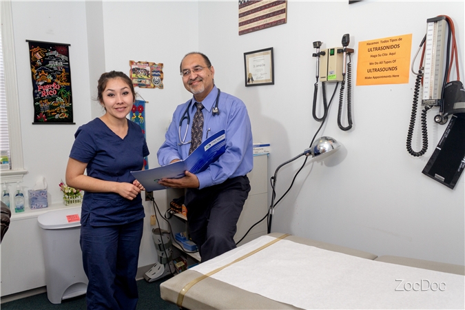 Dr. Zia reviewing a chart with a member of staff